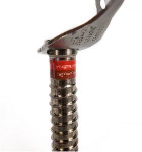 A two stripe wide, rectangular gear label on an ice screw.